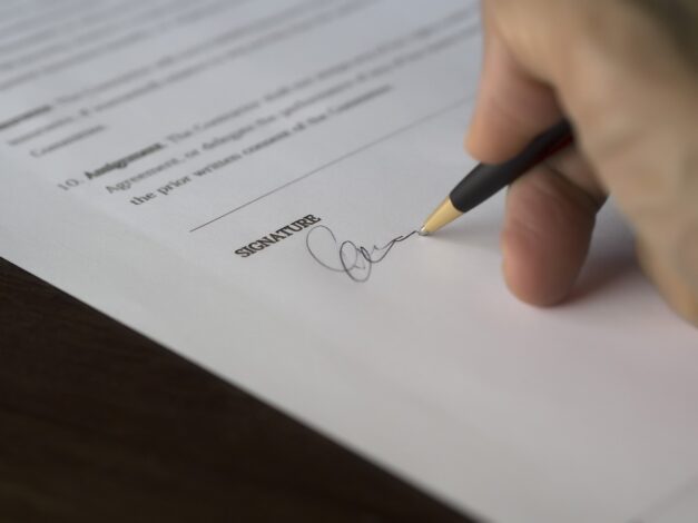 Divorce and separation lawyers often have to witness the signing of documents as shown here.