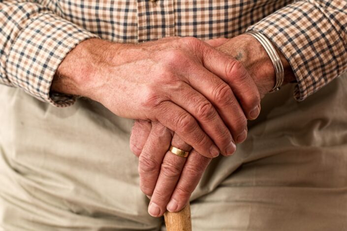 Old man holds a walking stick between his hands. He has lent his son money and wants to know how it will be repaid now he is separating from his wife.